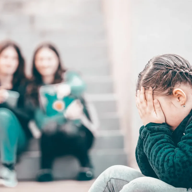 Girl being bullied at the school. Educational school isolation and bullying concept.