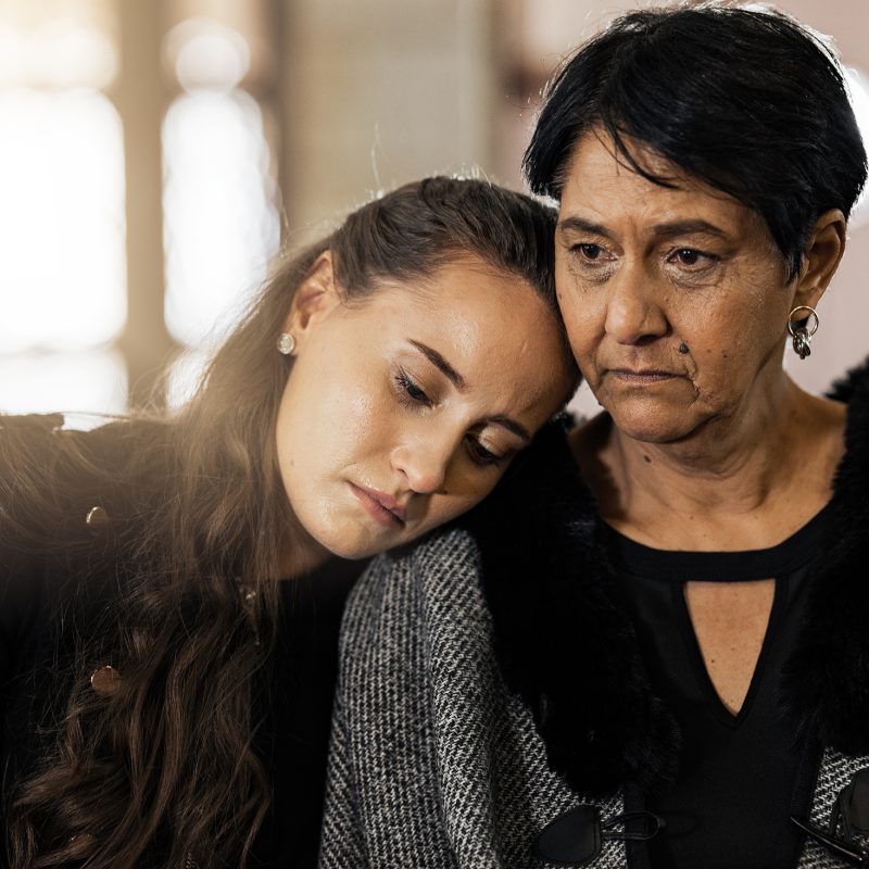 Sad, empathy and funeral with women in church for mourning, grief and death. Loss, respect and cons.