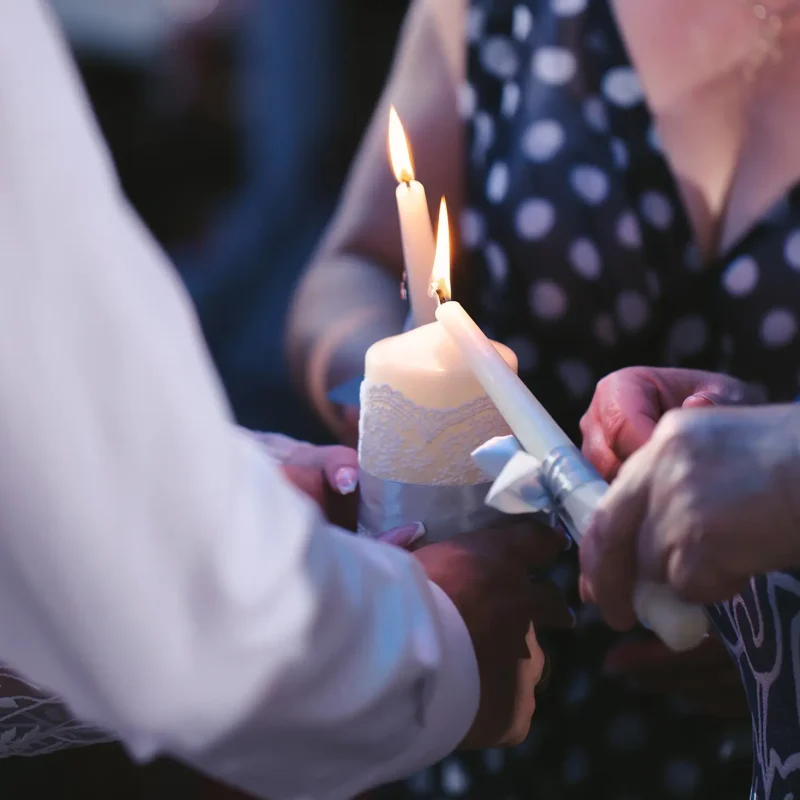 Wedding ceremony, paraphernalia, the bride and groom hold a large candle in their hand