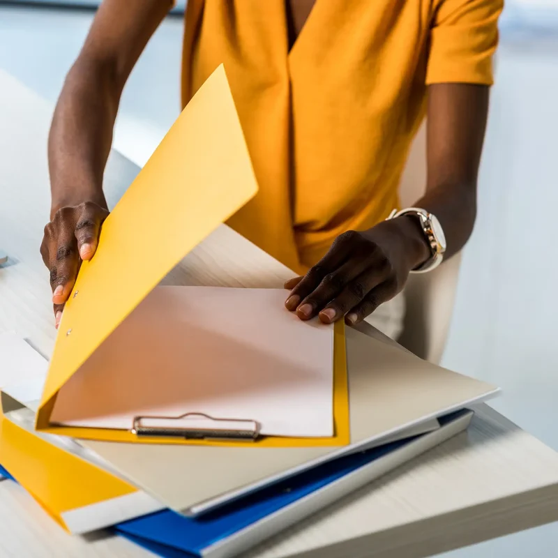 cropped shot of african american woman with folders remote working at home office