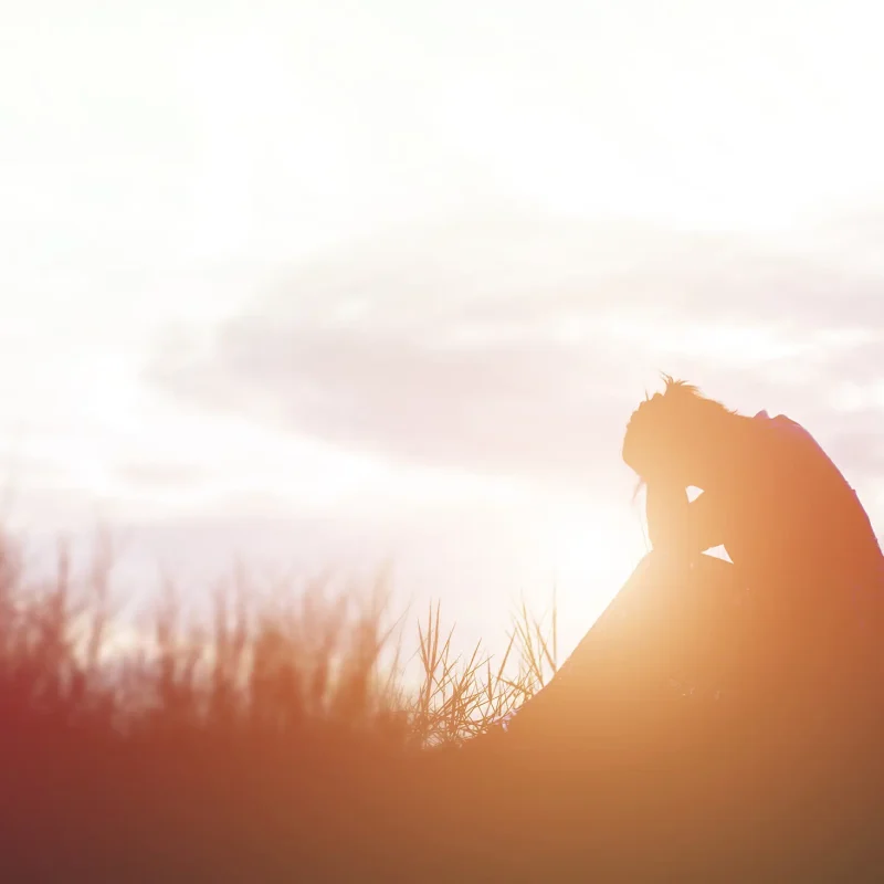 silhouette-of-person-seated-at-sunset-in-field-2026-03-26-06-51-19-utc